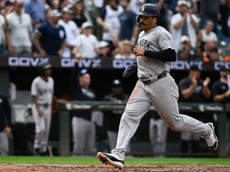 Sep 21, 2025; Baltimore, Maryland, USA;  New York Yankees outfielder Trent Grisham (12) scores on first base Ben Rice (not pictured) sixth inning single against the Baltimore Orioles at Oriole Park at Camden Yards. Mandatory Credit: Tommy Gilligan-Imagn Images