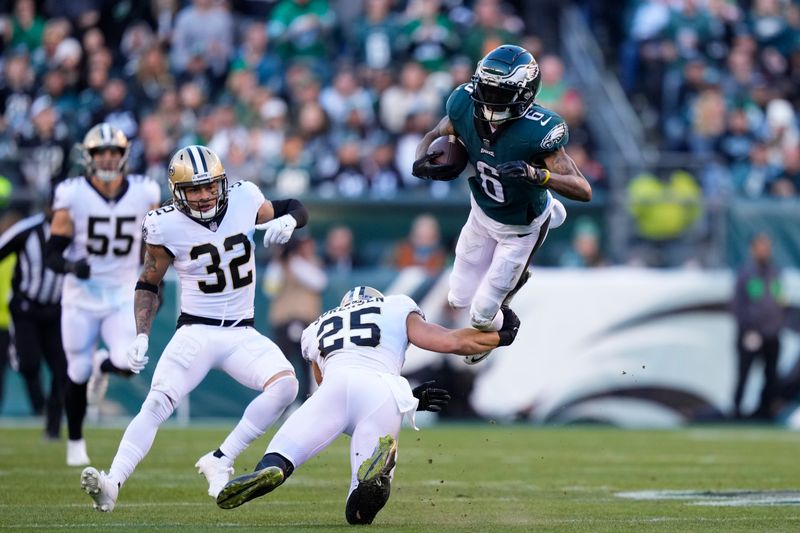 New Orleans Saints safety Daniel Sorensen (25) upends Philadelphia Eagles wide receiver DeVonta Smith (6) in the second half of an NFL football game in Philadelphia, Sunday, Jan. 1, 2023. (AP Photo/Matt Slocum)