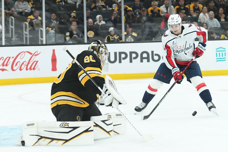 Sep 21, 2025; Boston, Massachusetts, USA; Washington Capitals forward Ivan Miroshnichenko (63) stick handles the puck in front of Boston Bruins goaltender Michael DiPietro (80) during the second period at TD Garden. Mandatory Credit: Bob DeChiara-Imagn Images