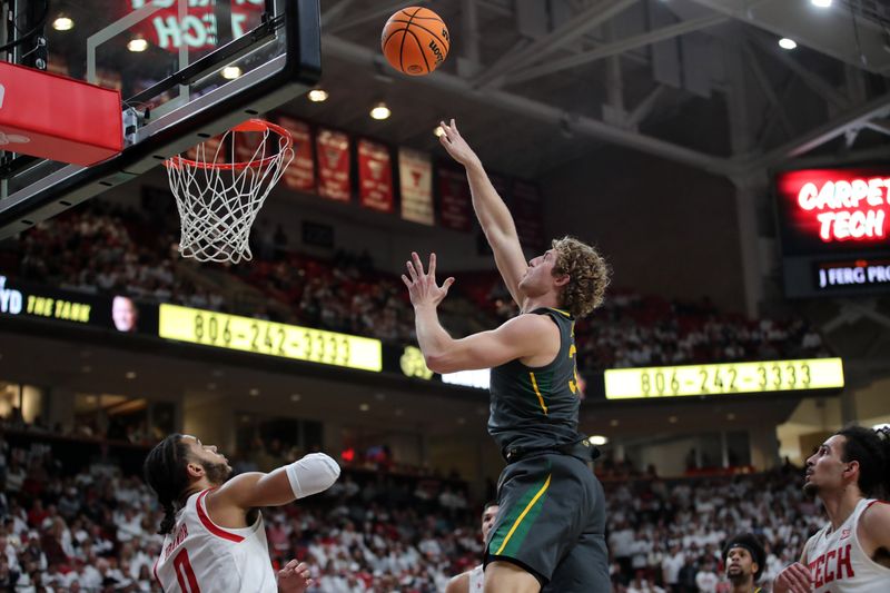 Jan 17, 2023; Lubbock, Texas, USA;  Baylor Bears forward Caleb Lohner (33) goes to the basket against Texas Tech Red Raiders forward Kevin Obanor (0) in the first half at United Supermarkets Arena. Mandatory Credit: Michael C. Johnson-USA TODAY Sports