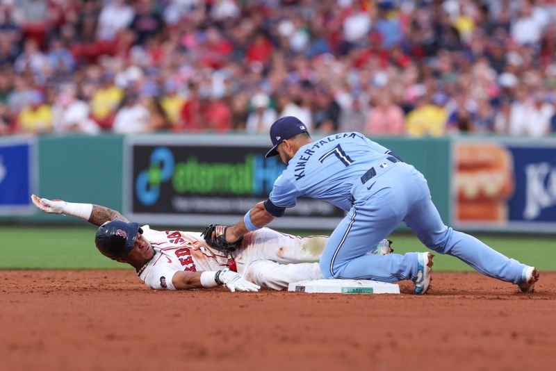 Jun 24, 2024; Boston, Massachusetts, USA; Boston Red Sox shortstop Ceddanne Rafaela (43) is tagged out by Toronto Blue Jays shortstop Isiah Kiner-Falefa (7) during the third inning at Fenway Park. Mandatory Credit: Paul Rutherford-USA TODAY Sports