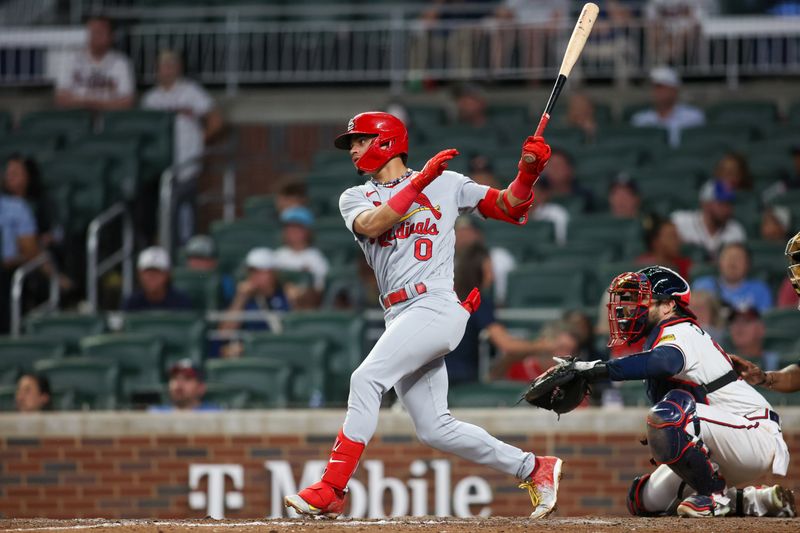 Sep 7, 2023; Atlanta, Georgia, USA; St. Louis Cardinals shortstop Masyn Winn (0) hits a RBI single against the Atlanta Braves in the ninth inning at Truist Park. Mandatory Credit: Brett Davis-USA TODAY Sports