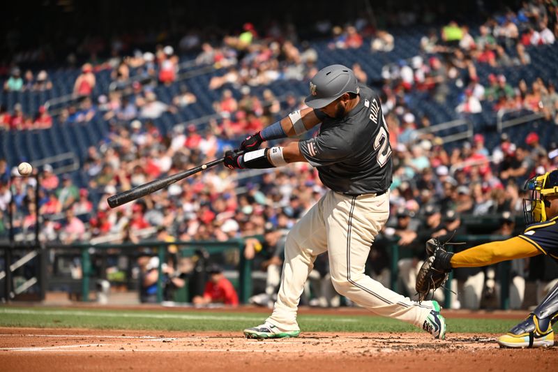 Aug 3, 2024; Washington, District of Columbia, USA; Washington Nationals catcher Keibert Ruiz (20) hits the ball into play to score a run against the Milwaukee Brewers during the first inning at Nationals Park. Mandatory Credit: Rafael Suanes-USA TODAY Sports