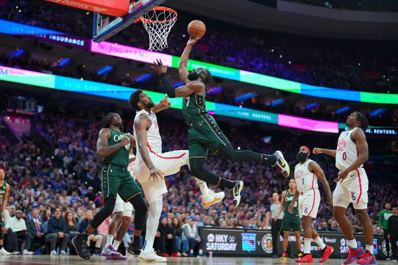 PHILADELPHIA, PA - FEBRUARY 25: Jaylen Brown #7 of the Boston Celtics shoots the ball against Joel Embiid #21 of the Philadelphia 76ers in the fourth quarter at the Wells Fargo Center on February 25, 2023 in Philadelphia, Pennsylvania. The Celtics defeated the 76ers 110-107. NOTE TO USER: User expressly acknowledges and agrees that, by downloading and or using this photograph, User is consenting to the terms and conditions of the Getty Images License Agreement. (Photo by Mitchell Leff/Getty Images)