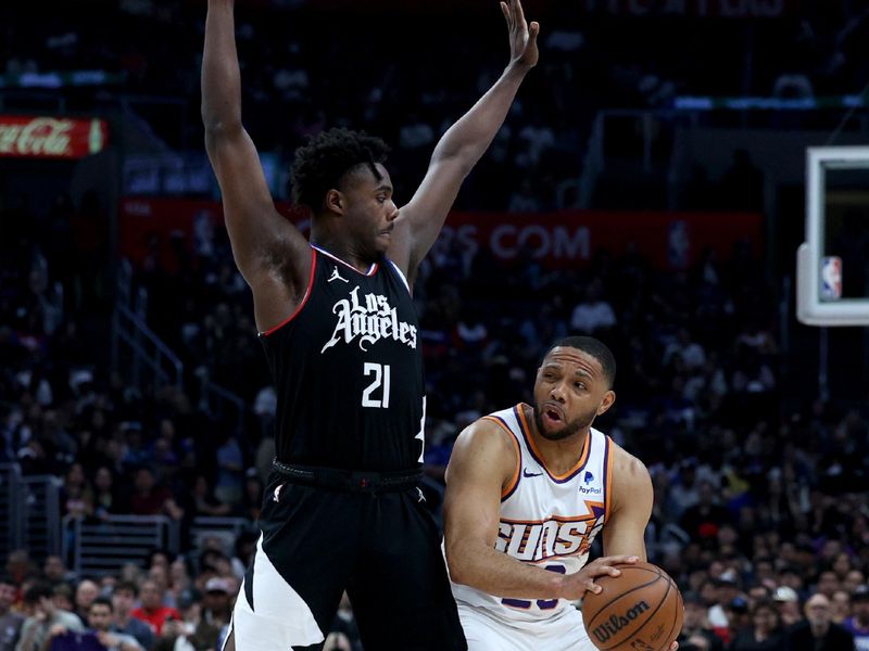 LOS ANGELES, CALIFORNIA - APRIL 10: Eric Gordon #23 of the Phoenix Suns looks to pass in front of Kobe Brown #21 of the LA Clippers during a 124-108 Suns win at Crypto.com Arena on April 10, 2024 in Los Angeles, California. User is consenting to the terms and conditions of the Getty Images License Agreement.  (Photo by Harry How/Getty Images)