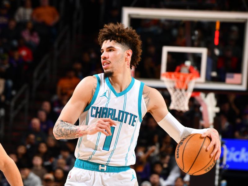 PHOENIX, AZ - JANUARY 12: LaMelo Ball #1 of the Charlotte Hornets looks on during the game against the Phoenix Suns on January 12, 2025 at Footprint Center in Phoenix, Arizona. NOTE TO USER: User expressly acknowledges and agrees that, by downloading and or using this photograph, user is consenting to the terms and conditions of the Getty Images License Agreement. Mandatory Copyright Notice: Copyright 2025 NBAE (Photo by Barry Gossage/NBAE via Getty Images)