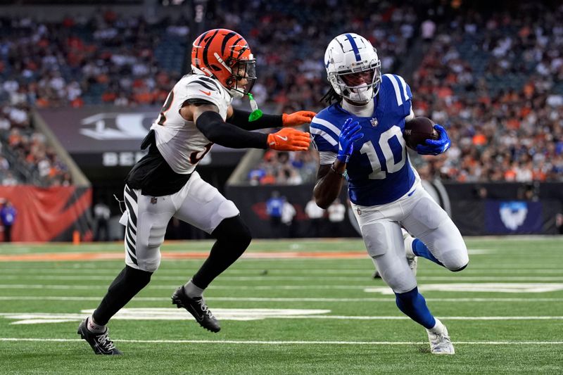 Indianapolis Colts wide receiver Adonai Mitchell (10) runs from Cincinnati Bengals safety Daijahn Anthony, left, during a 9-yard touchdown reception in the first half of a preseason NFL football game, Thursday, Aug. 22, 2024, in Cincinnati. (AP Photo/Carolyn Kaster)