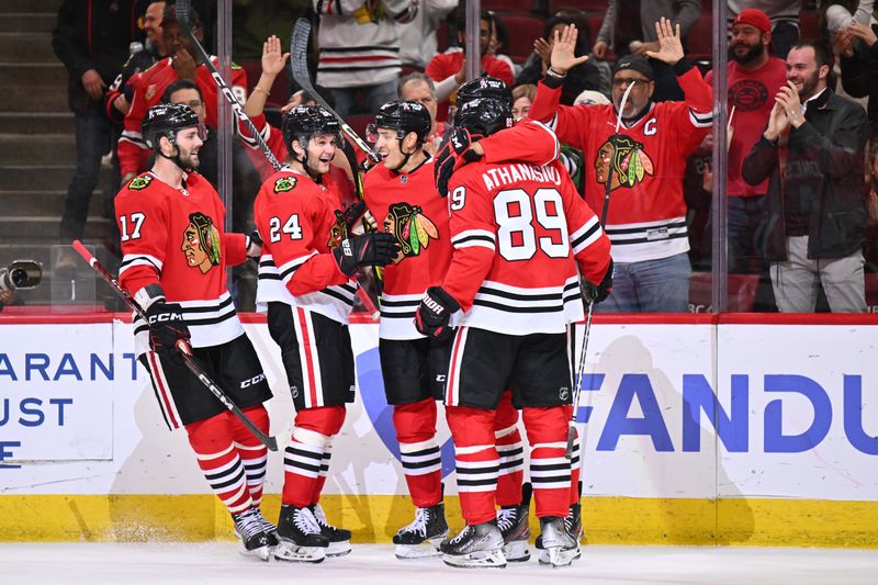 Mar 6, 2023; Chicago, Illinois, USA;  Chicago Blackhawks forward Jason Dickinson (17), forward Anders Bjork (24), defenseman Caleb Jones (82) and forward Andreas Athanasiou (89) celebrate with defenseman Seth Jones (4) after Seth Jones scored his second goal of the second period against the Ottawa Senators at United Center. Mandatory Credit: Jamie Sabau-USA TODAY Sports