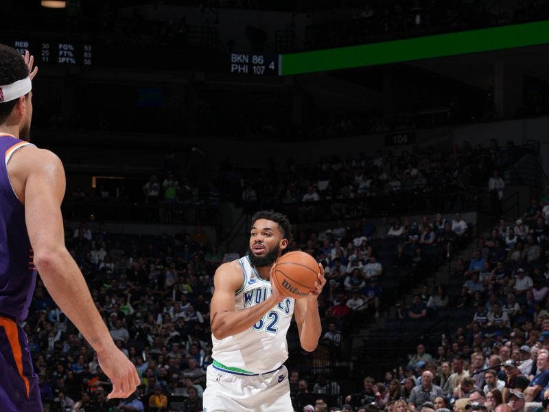 MINNEAPOLIS, MN -  APRIL 14: Karl-Anthony Towns #32 of the Minnesota Timberwolves handles the ball during the game against the Phoenix Suns on April 14, 2024 at Target Center in Minneapolis, Minnesota. NOTE TO USER: User expressly acknowledges and agrees that, by downloading and or using this Photograph, user is consenting to the terms and conditions of the Getty Images License Agreement. Mandatory Copyright Notice: Copyright 2024 NBAE (Photo by Jordan Johnson/NBAE via Getty Images)