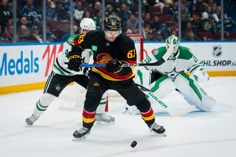 Nov 20, 2025; Vancouver, British Columbia, CAN; Dallas Stars defenseman Miro Heiskanen (4) defends against Vancouver Canucks forward Max Sasson (63) in the second period at Rogers Arena. Mandatory Credit: Bob Frid-Imagn Images