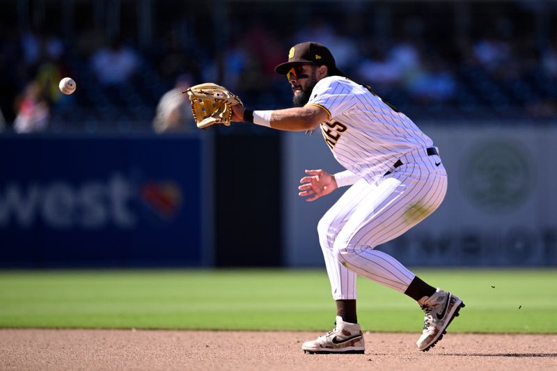 Sep 6, 2023; San Diego, California, USA; San Diego Padres second baseman Fernando Tatis Jr. (23) fields a ground ball during the ninth inning against the Philadelphia Phillies at Petco Park. Mandatory Credit: Orlando Ramirez-USA TODAY Sports