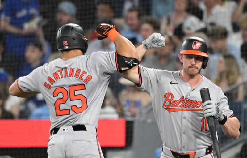 Jun 5, 2024; Toronto, Ontario, CAN;   Baltimore Orioles designated hitter Anthony Santander (25) celebrates with second baseman Jordan Westburg (11) after hitting a solo home run against the Toronto Blue Jays in the second inning at Rogers Centre. Mandatory Credit: Dan Hamilton-USA TODAY Sports 