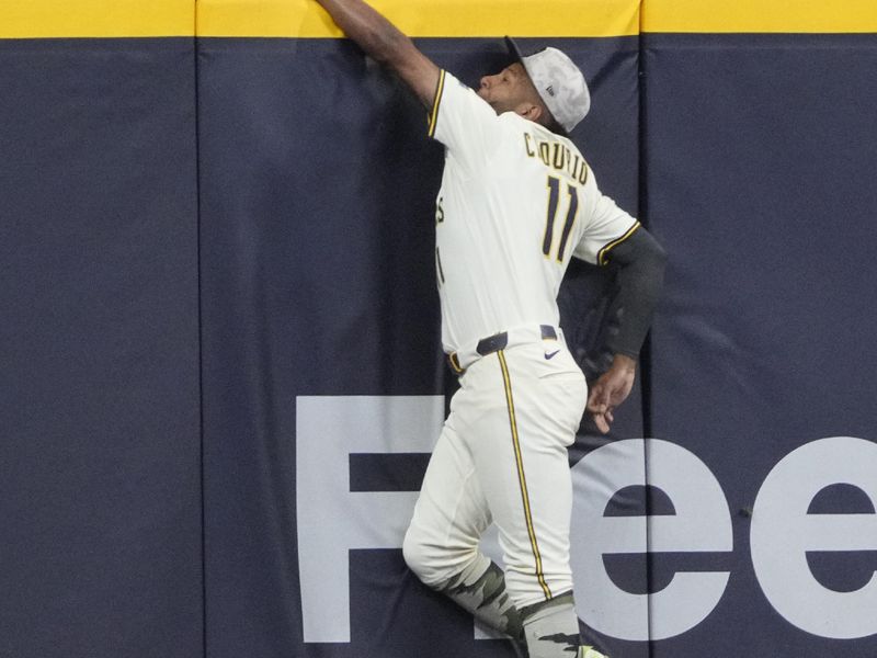 May 18, 2025; Milwaukee, Wisconsin, USA; Milwaukee Brewers outfielder Jackson Chourio (11) keeps a home run from going over the wall against the Minnesota Twins in the eighth inning at American Family Field. Mandatory Credit: Michael McLoone-Imagn Images