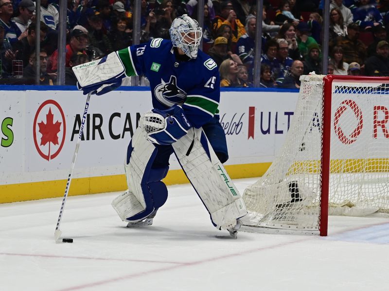 Mar 23, 2024; Vancouver, British Columbia, CAN; Vancouver Canucks goaltender Casey DeSmith (29) controls the puck against Calgary Flames during the second period at Rogers Arena. Mandatory Credit: Simon Fearn-USA TODAY Sports