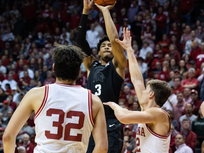 Jan 22, 2023; Bloomington, Indiana, USA; Michigan State Spartans guard Jaden Akins (3) shoots the ball while Indiana Hoosiers forward Miller Kopp (12) defends in the second half at Simon Skjodt Assembly Hall. Mandatory Credit: Trevor Ruszkowski-USA TODAY Sports