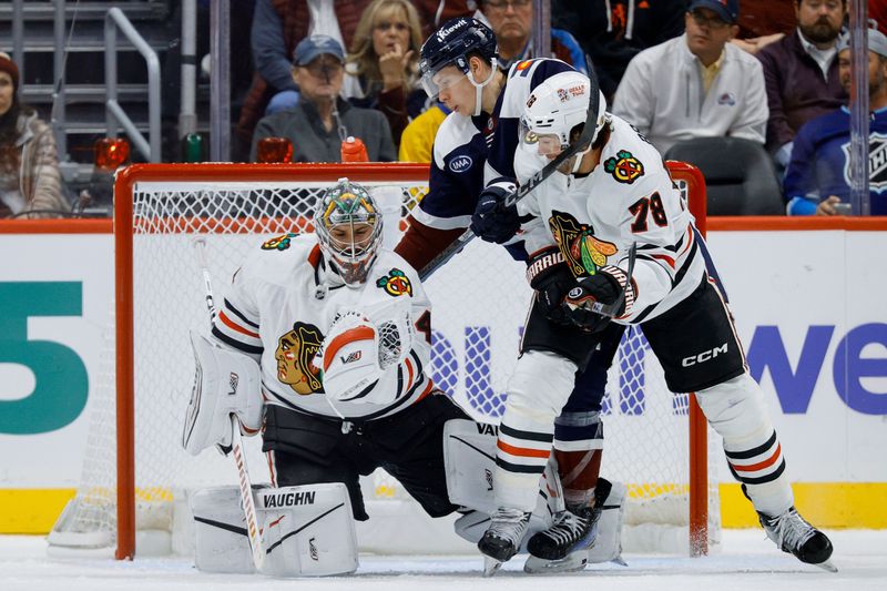 Oct 28, 2024; Denver, Colorado, USA; Chicago Blackhawks defenseman TJ Brodie (78) is high sticked by Colorado Avalanche center Ivan Ivan (82) as Chicago Blackhawks goaltender Petr Mrazek (34) makes a save in the third period at Ball Arena. Mandatory Credit: Isaiah J. Downing-Imagn Images