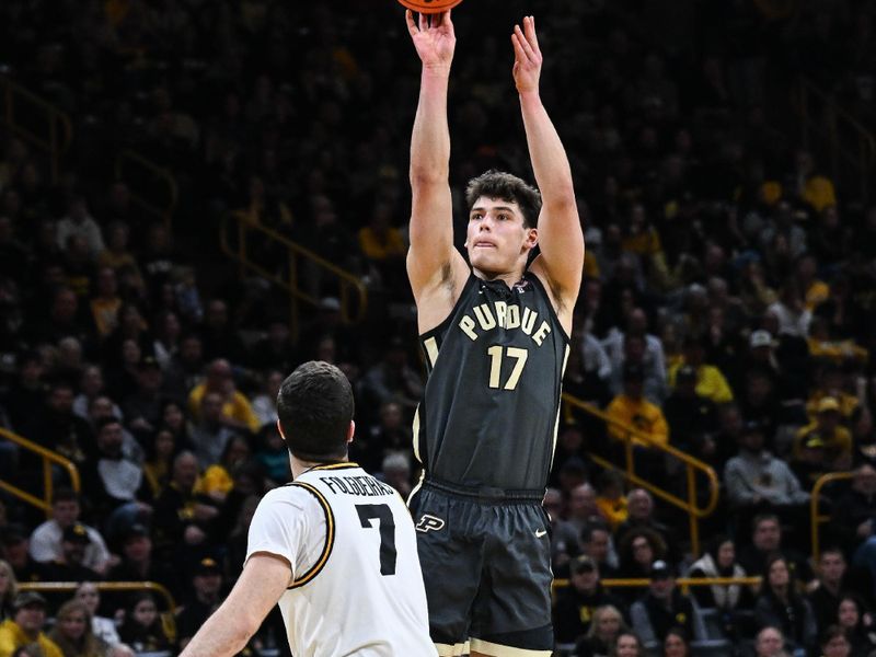 Feb 14, 2026; Iowa City, Iowa, USA; Purdue Boilermakers guard Omer Mayer (17) shoots the ball as Iowa Hawkeyes forward Alvaro Folgueiras (7) defends during the first half at Carver-Hawkeye Arena. Mandatory Credit: Jeffrey Becker-Imagn Images
