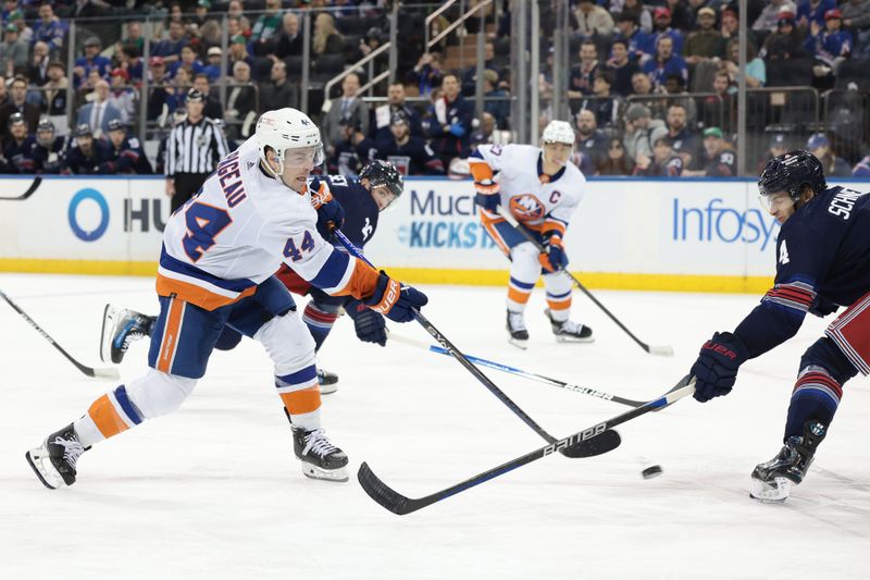 Mar 17, 2024; New York, New York, USA; New York Islanders center Jean-Gabriel Pageau (44) shoots the puck as New York Rangers defenseman Braden Schneider (4) defends during the second period at Madison Square Garden. Mandatory Credit: Vincent Carchietta-USA TODAY Sports