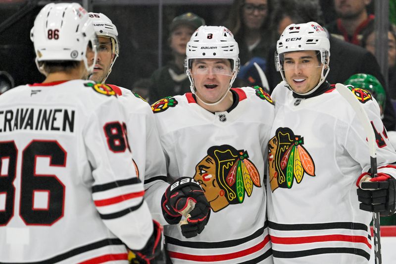 Nov 29, 2024; Saint Paul, Minnesota, USA;  Chicago Blackhawks forward Ryan Donato (8) celebrates his goal against the Minnesota Wild with forward Teuvo Teravainen (86), defenseman Alec Martinez (25), and defenseman Wyatt Kaiser (44) during the first period at Xcel Energy Center. Mandatory Credit: Nick Wosika-Imagn Images