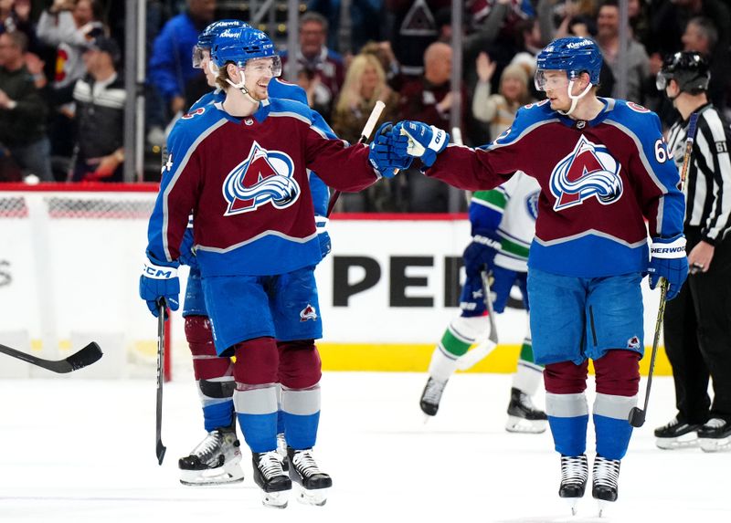 Feb 20, 2024; Denver, Colorado, USA; Colorado Avalanche left wing Artturi Lehkonen (62) celebrates his empty net goal with Colorado Avalanche right wing Oskar Olausson (24) in the third period against the Vancouver Canucks at Ball Arena. Mandatory Credit: Ron Chenoy-USA TODAY Sports