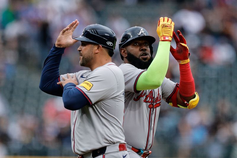 Aug 9, 2024; Denver, Colorado, USA; Atlanta Braves designated hitter Marcell Ozuna (20) celebrates with third base coach Matt Tuiasosopo (89) as he rounds the bases on a solo home run in the first inning against the Colorado Rockies at Coors Field. Mandatory Credit: Isaiah J. Downing-USA TODAY Sports