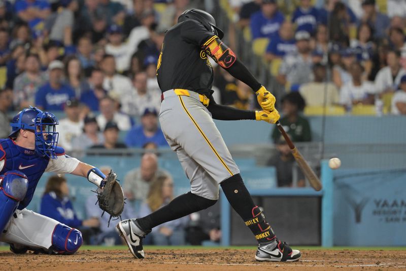 Aug 9, 2024; Los Angeles, California, USA; Pittsburgh Pirates shortstop Oneil Cruz (15) hits a solo home run in the fourth inning against the Los Angeles Dodgers at Dodger Stadium. Mandatory Credit: Jayne Kamin-Oncea-USA TODAY Sports