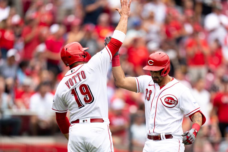 Aug 9, 2023; Cincinnati, OH, USA; Cincinnati Reds first baseman Christian Encarnacion-Strand (33) greets Cincinnati Reds first baseman Joey Votto (19) after hitting a 2-run home run in the fourth inning of the MLB baseball game between Cincinnati Reds and Miami Marlins at Great American Ball Park in Cincinnati on Wednesday, Aug. 9, 2023.  Mandatory Credit: Albert Cesare-USA TODAY Sports