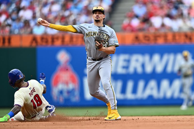 Jun 5, 2024; Philadelphia, Pennsylvania, USA; Milwaukee Brewers infielder Willy Adames (27) turns a double play over Philadelphia Phillies outfielder Cristian Pache (19) in the fifth inning at Citizens Bank Park. Mandatory Credit: Kyle Ross-USA TODAY Sports