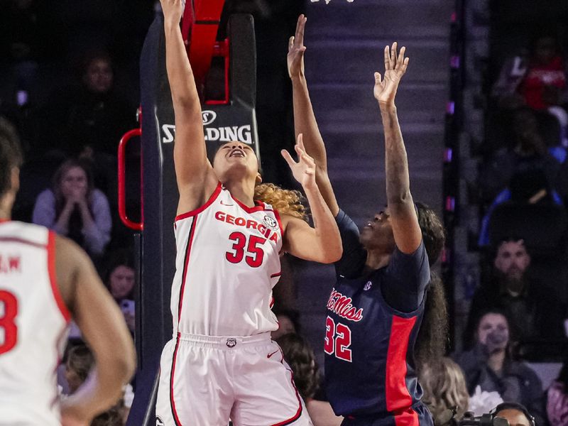 Jan 21, 2024; Athens, Georgia, USA; Georgia Bulldogs forward Javyn Nicholson (35) lays in a basket over Ole Miss Rebels center Rita Igbokwe (32) during the second half at Stegeman Coliseum. Mandatory Credit: Dale Zanine-USA TODAY Sports