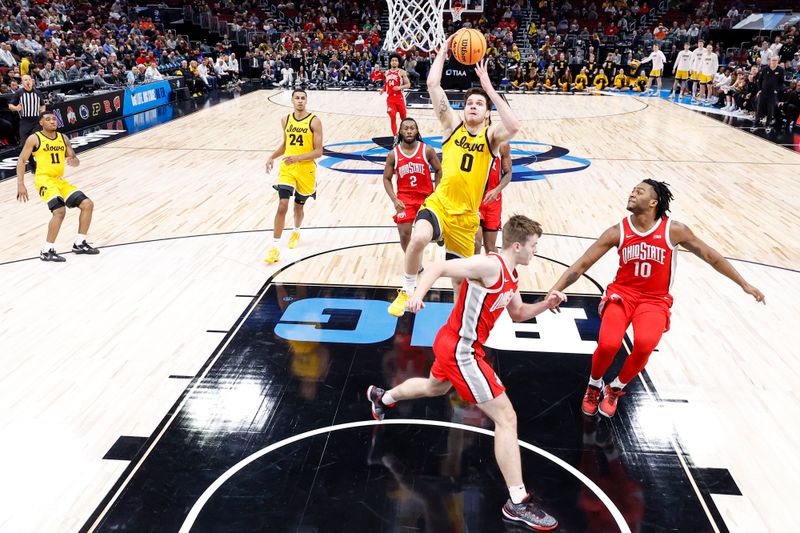 Mar 9, 2023; Chicago, IL, USA; Iowa Hawkeyes forward Filip Rebraca (0) drives to the basket against the Ohio State Buckeyes during the first half at United Center. Mandatory Credit: Kamil Krzaczynski-USA TODAY Sports