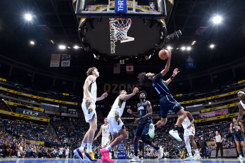 ORLANDO, FL - NOVEMBER 13: Anthony Black #0 of the Orlando Magic drives to the basket during the game against the Indiana Pacers on November 13, 2024 at Kia Center in Orlando, Florida. NOTE TO USER: User expressly acknowledges and agrees that, by downloading and or using this photograph, User is consenting to the terms and conditions of the Getty Images License Agreement. Mandatory Copyright Notice: Copyright 2024 NBAE (Photo by Fernando Medina/NBAE via Getty Images)