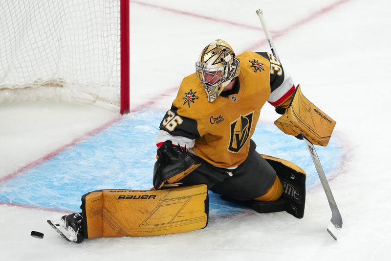 Apr 16, 2024; Las Vegas, Nevada, USA; Vegas Golden Knights goaltender Logan Thompson (36) makes a skate save against the Chicago Blackhawks during the first period at T-Mobile Arena. Mandatory Credit: Stephen R. Sylvanie-USA TODAY Sports