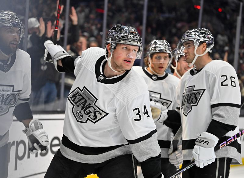 Apr 10, 2023; Los Angeles, California, USA;  Los Angeles Kings right wing Arthur Kaliyev (34), second from left, celebrates after scoring a goal in the second period against the Vancouver Canucks at Crypto.com Arena. Mandatory Credit: Jayne Kamin-Oncea-USA TODAY Sports