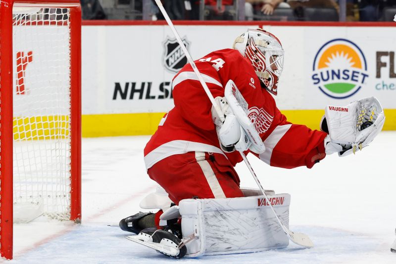 Jan 7, 2025; Detroit, Michigan, USA; Detroit Red Wings goaltender Alex Lyon (34) makes a save in the first period against the Ottawa Senators at Little Caesars Arena. Mandatory Credit: Rick Osentoski-Imagn Images