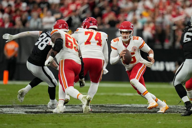 Kansas City Chiefs quarterback Patrick Mahomes (15) runs with the ball during the first half of an NFL football game against the Las Vegas Raiders Sunday, Oct. 27, 2024, in Las Vegas. (AP Photo/John Locher)