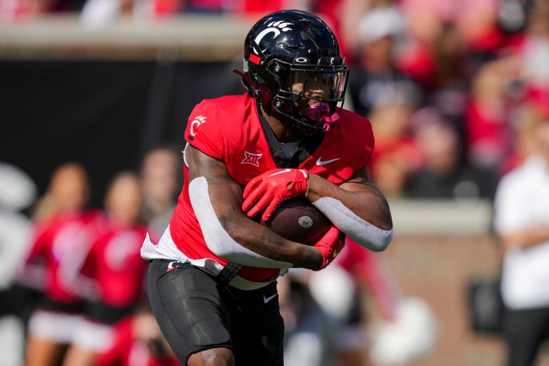 Oct 14, 2023; Cincinnati, Ohio, USA;  Cincinnati Bearcats running back Myles Montgomery (26) carries the ball against the Iowa State Cyclones in the first half at Nippert Stadium. Mandatory Credit: Aaron Doster-USA TODAY Sports