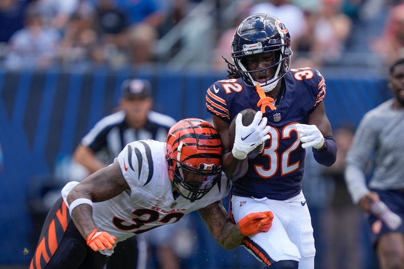 Cincinnati Bengals running back Trayveon Williams (32) knocks Chicago Bears cornerback Terell Smith (32) out-of-bounds after Smith made an interception during the second half of an NFL preseason football game, Saturday, Aug. 17, 2024, at Soldier Field in Chicago. (AP Photo/Charles Rex Arbogast)