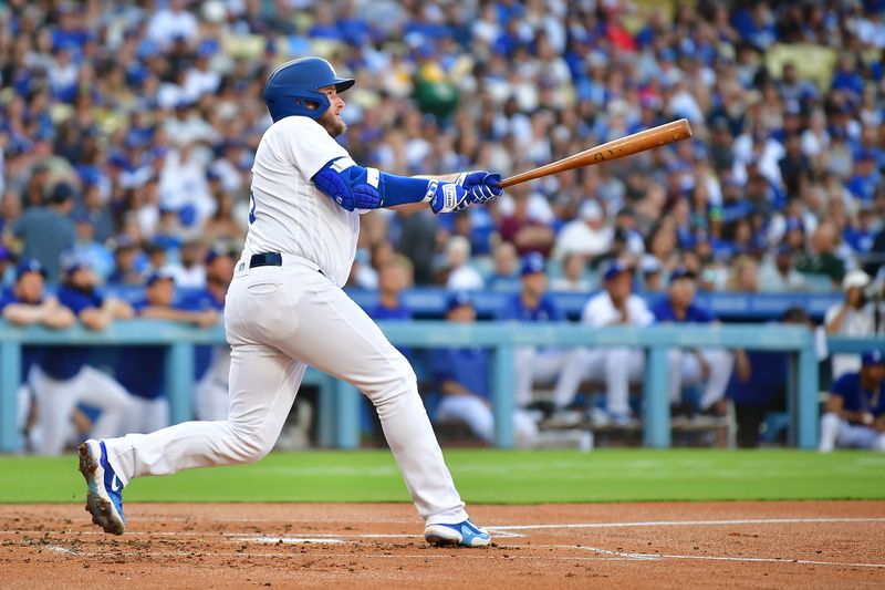 Jul 29, 2023; Los Angeles, California, USA; Los Angeles Dodgers third baseman Max Muncy (13) hits a two run home run against the Cincinnati Reds during the first inning at Dodger Stadium. Mandatory Credit: Gary A. Vasquez-USA TODAY Sports