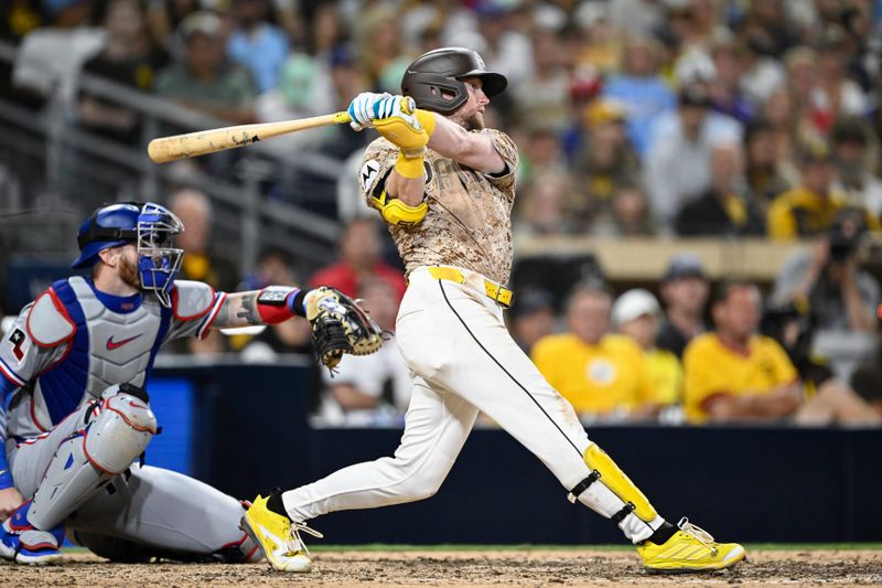 Jul 6, 2025; San Diego, California, USA; San Diego Padres second baseman Jake Cronenworth (9) hits an RBI single during the seventh inning against the Texas Rangers at Petco Park. Mandatory Credit: Denis Poroy-Imagn Images