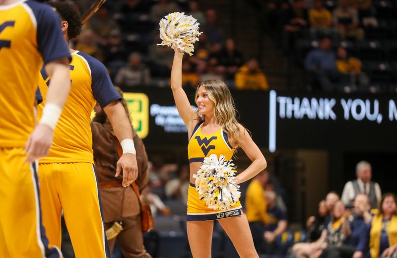 Mar 6, 2024; Morgantown, West Virginia, USA; A West Virginia Mountaineers cheerleader performs during the second half against the TCU Horned Frogs at WVU Coliseum. Mandatory Credit: Ben Queen-USA TODAY Sports