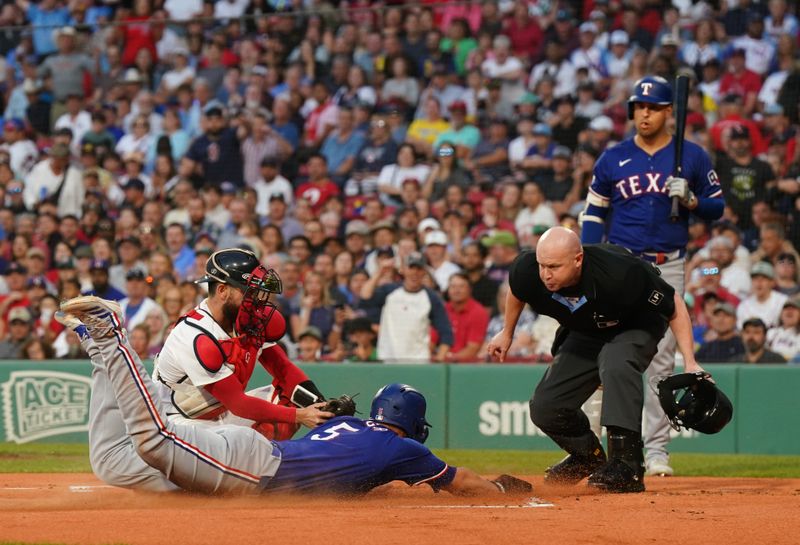 Aug 12, 2024; Boston, Massachusetts, USA; Texas Rangers shortstop Corey Seager (5) tagged out at home plate by Boston Red Sox catcher Connor Wong (12) in the first inning at Fenway Park. Mandatory Credit: David Butler II-USA TODAY Sports