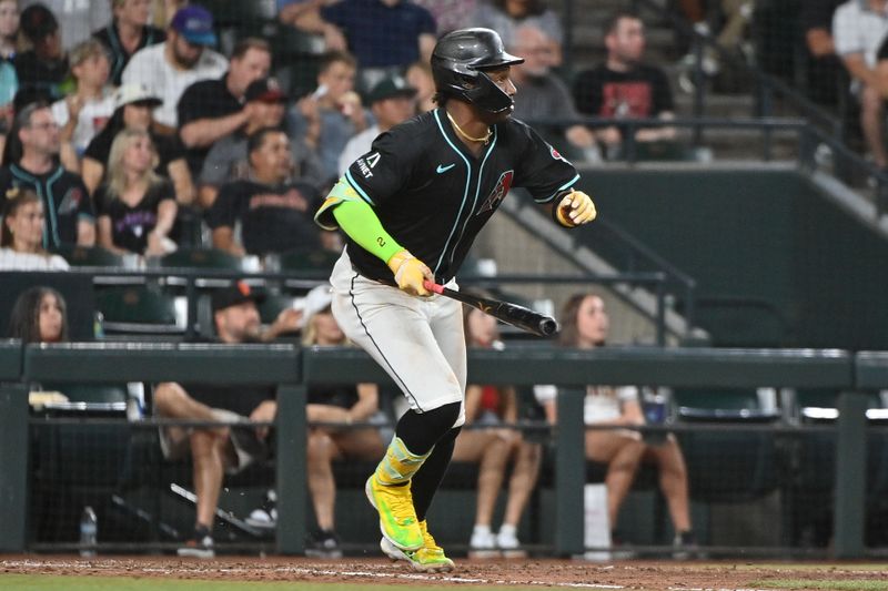 Jun 30, 2025; Phoenix, Arizona, USA;  Arizona Diamondbacks shortstop Geraldo Perdomo (2) hits an RBI single in the seventh inning against the San Francisco Giants at Chase Field. Mandatory Credit: Matt Kartozian-Imagn Images