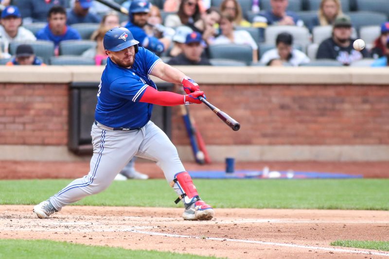 Jun 3, 2023; New York City, New York, USA;  Toronto Blue Jays catcher Alejandro Kirk (30) hits a single in the fourth inning against the New York Mets at Citi Field. Mandatory Credit: Wendell Cruz-USA TODAY Sports