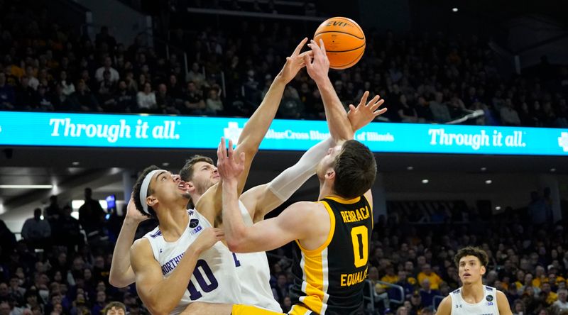 Feb 19, 2023; Evanston, Illinois, USA; Northwestern Wildcats forward Tydus Verhoeven (10) defends Iowa Hawkeyes forward Filip Rebraca (0) during the first half at Welsh-Ryan Arena. Mandatory Credit: David Banks-USA TODAY Sports