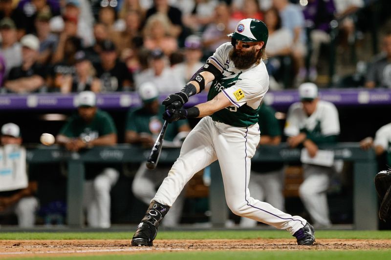 Jul 6, 2024; Denver, Colorado, USA; Colorado Rockies designated hitter Charlie Blackmon (19) hits a double in the seventh inning against the Kansas City Royals at Coors Field. Mandatory Credit: Isaiah J. Downing-USA TODAY Sports