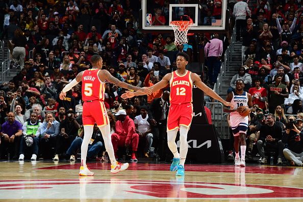 ATLANTA, GA - OCTOBER 30: Dejounte Murray #5 high fives De'Andre Hunter #12 of the Atlanta Hawks during the game against the Minnesota Timberwolves on October 30, 2023 at State Farm Arena in Atlanta, Georgia.  NOTE TO USER: User expressly acknowledges and agrees that, by downloading and/or using this Photograph, user is consenting to the terms and conditions of the Getty Images License Agreement. Mandatory Copyright Notice: Copyright 2023 NBAE (Photo by Scott Cunningham/NBAE via Getty Images)