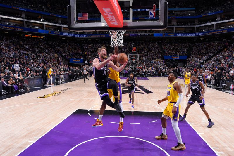 SACRAMENTO, CA - MARCH 13:  Domantas Sabonis #10 of the Sacramento Kings drives to the basket during the game against the Los Angeles Lakers on March 13, 2024 at Golden 1 Center in Sacramento, California. NOTE TO USER: User expressly acknowledges and agrees that, by downloading and or using this Photograph, user is consenting to the terms and conditions of the Getty Images License Agreement. Mandatory Copyright Notice: Copyright 2024 NBAE (Photo by Rocky Widner/NBAE via Getty Images)