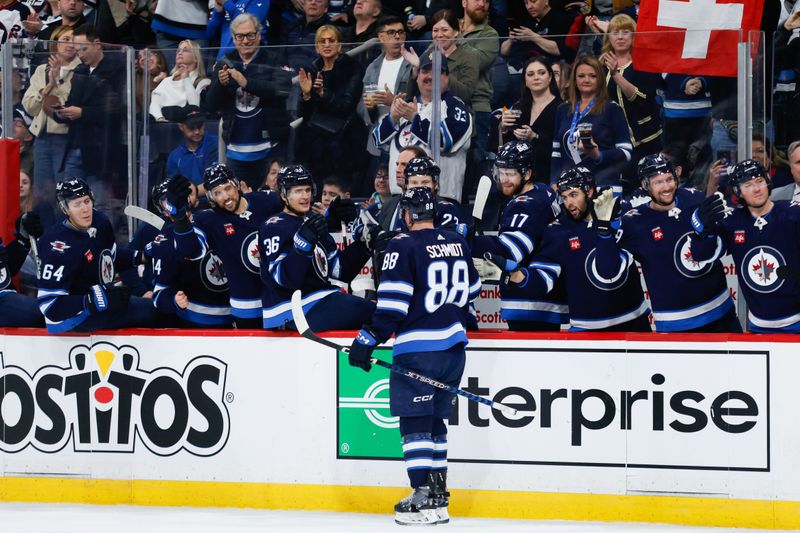 Mar 15, 2024; Winnipeg, Manitoba, CAN; Winnipeg Jets defenseman Nate Schmidt (88) is congratulated by his team mates on his goal against the Anaheim Ducks during the second period at Canada Life Centre. Mandatory Credit: Terrence Lee-USA TODAY Sports