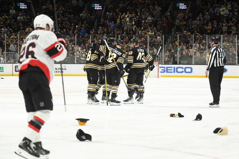 Mar 19, 2024; Boston, Massachusetts, USA;  Boston Bruins fans throw hats on the ice after a hat trick by Boston Bruins right wing David Pastrnak (88) during the third period against the Ottawa Senators at TD Garden. Mandatory Credit: Bob DeChiara-USA TODAY Sports