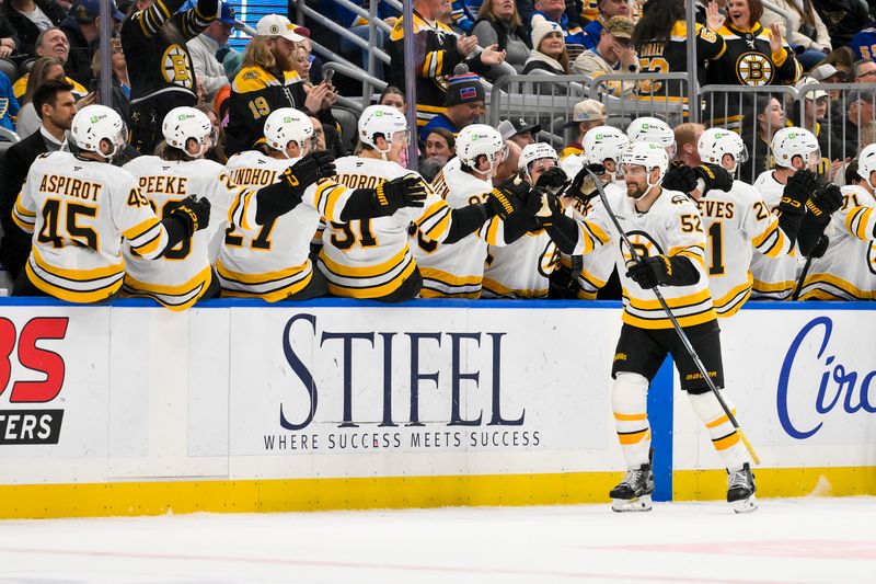 Dec 9, 2025; St. Louis, Missouri, USA; Boston Bruins center Sean Kuraly (52) is congratulated by teammates after scoring against the St. Louis Blues during the second period at Enterprise Center. Mandatory Credit: Jeff Curry-Imagn Images